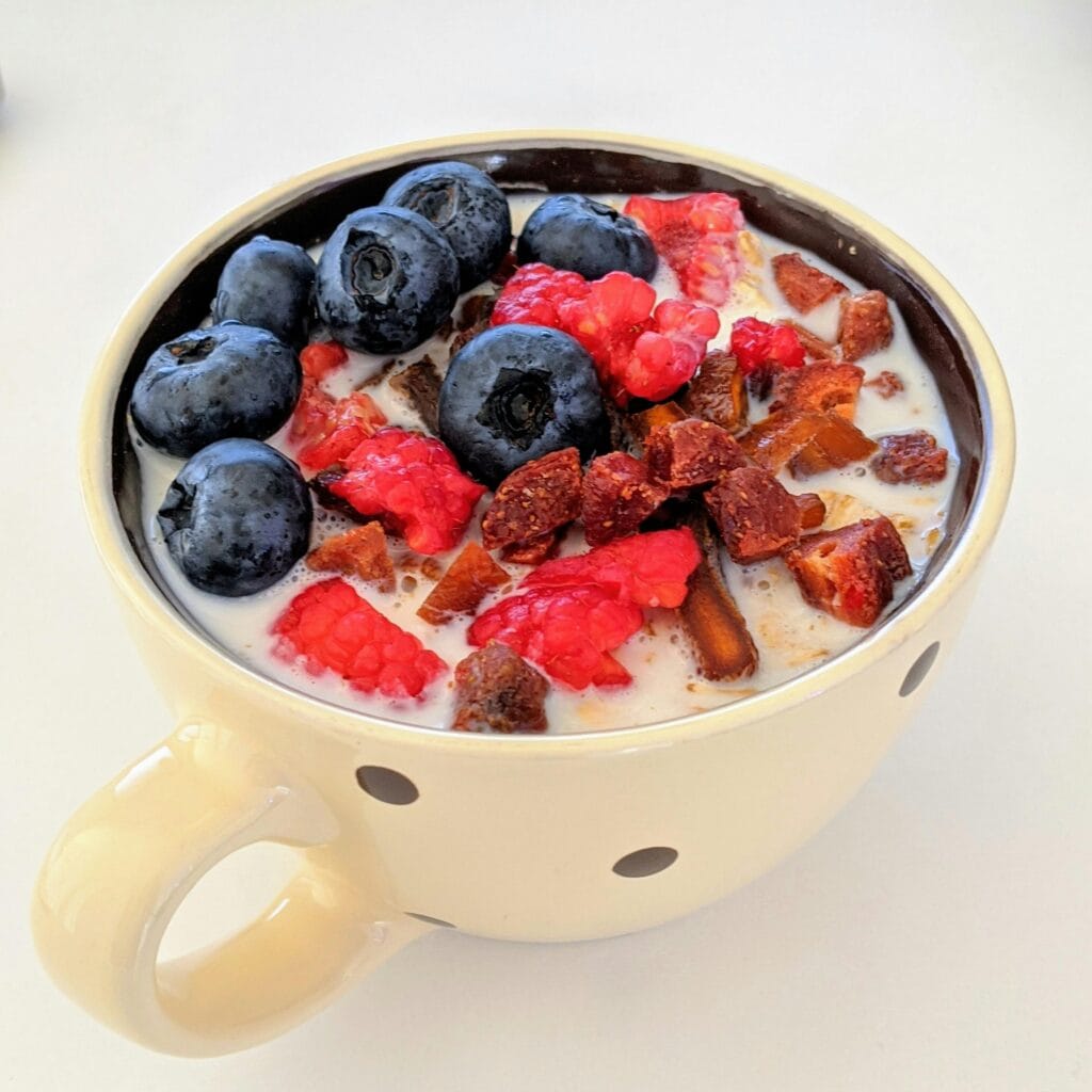 Happy Baby Organic Yogis freeze-dried yogurt snacks in pouch packaging with fruit scattered